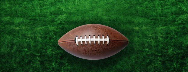 Obraz premium American football in middle grass field top view copy space