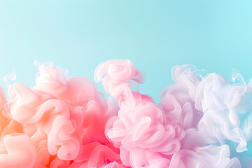 Fototapeta premium Colorful ink swirling in water against a blue background. Soft hues of pink, purple, and orange create a dreamy and elegant effect.
