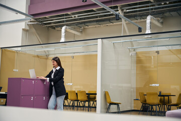Girl stands in an empty office space