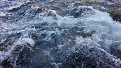 Abstract blue sea water with white wave for background.