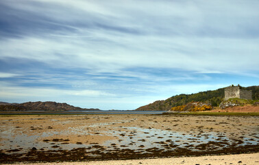 A view at very low tide of the mudflats on the estuary as the River Shiel makes its way to the sea by Castle Tioram. Scotland