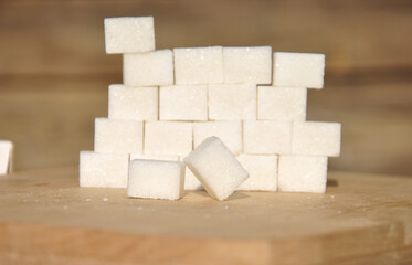 sugar cubes on a wooden background. sugar cubes close-up. selective focus and blurred background