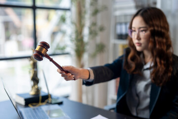 A woman in a suit holding a gavel