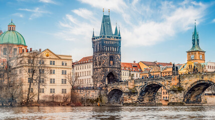 View of the city of Prague and Vltava river with Charles bridge with Old Town Bridge Tower in Prague, Czech Republic.