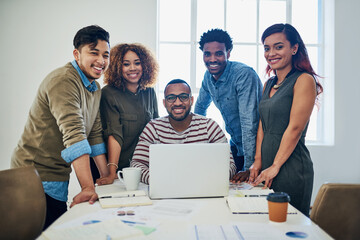 Portrait, employees and happy in office with laptop for teamwork, collaboration and strategy. People, about us and smile or confident in boardroom with paperwork for project and business growth