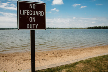 "No lifeguard on Duty" sign at the swimming beach in summer at Pike Lake Unit, Kettle Moraine State Forest, Hartford,, Wisconsin