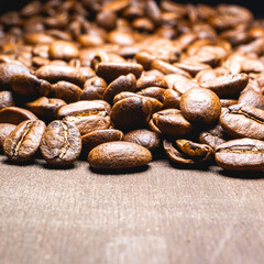 Close up from a bunch of coffee beans laying down. Backdrop for coffee products.
