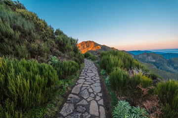 Hiking on the highest peak of Madeira Pico Ruivo next to the cottage Abrigo do Pico Ruivo. Views of...