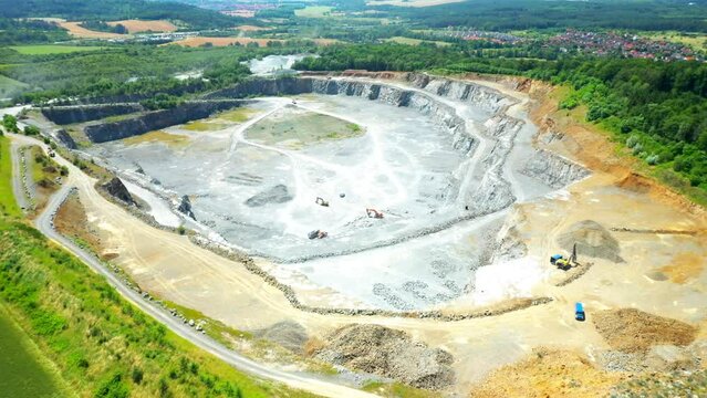 Stone quarry. Open cast mining. Industrial landscape. Heavy industry from above. Aerial view to big source of emissions.
