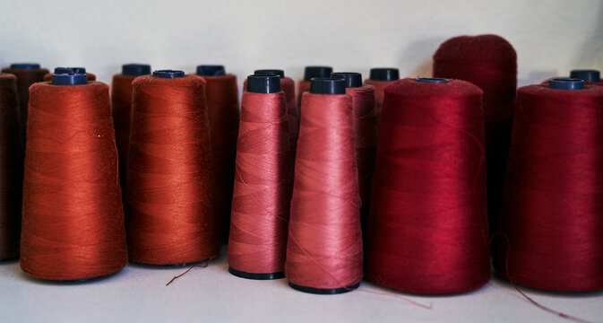 Retail, business or red thread on shelf in shop for fashion, design or clothes creation, production or seamstress service. Distribution, supply chain or cotton string in warehouse for workshop tools
