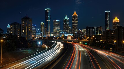 Fototapeta premium City nights: A bustling highway with glowing headlights and light trails from passing cars leads to a towering, illuminated city skyline, capturing urban energy