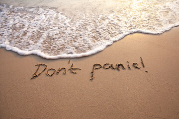 Fototapeta premium don't panic message on sand, calm down, no panic, anxiety and mental health concept