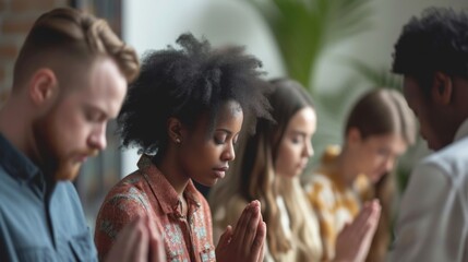 A group of employees prays together for support and encouragement in the workplace