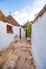 Trulli of Alberobello, Puglia, Italy. town of Alberobello with trulli houses among green plants and flowers