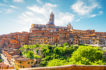 Fototapeta premium Siena, medieval town in Tuscany, with view of the Dome & Bell Tower of Siena Cathedral, Mangia Tower and Basilica of San Domenico, Italy