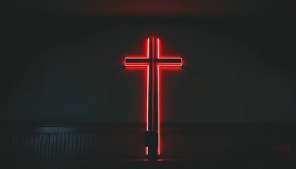 Radiant neon cross shines brightly in the darkness of the room