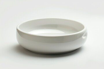A simple white bowl sitting on a table, perfect for everyday use or as a decorative piece