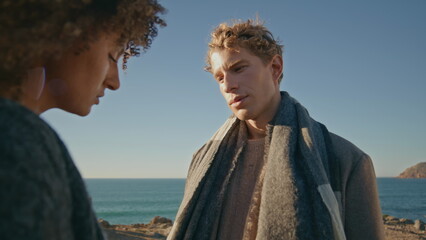 Fototapeta premium Two people feeling sad at beach closeup. Man woman contemplating at sea coast