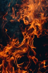 Fototapeta premium A close-up shot of a fire burning brightly on a black background, with flames and sparks visible