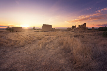 Rear view at sunset of the deserted ruins of Villacreces, Valladolid. Concept of depopulation and...