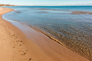 The calm water of Lake Michigan recede from the shoreline beach at Harrington Beach State Park, Belgium, Wisconsin in early November