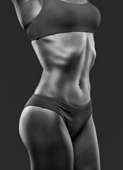 Naklejka premium A young beautiful woman with a slim and muscular figure and dark skin in blue underwear. The concept of weight loss and healthy lifestyle.