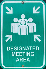A green sign for a designated meeting area