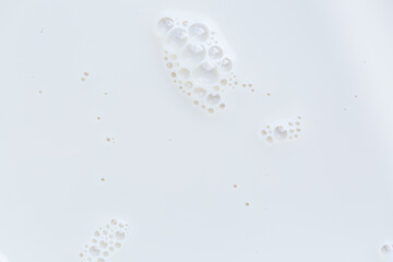 Close-up cow's milk background,Frothy Milk Bubble Pattern,Foam of milkshake, cocktail with bubbles as texture or background, top view