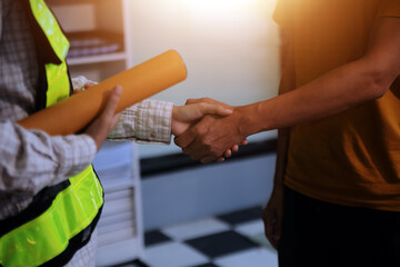 Architect men making handshake in construction site. Employee or worker shake hands to employer man for greeting, dealing, teamwork, collaboration some project or business. They are good team