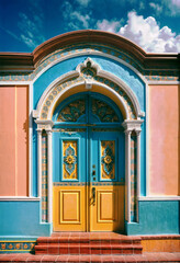Fototapeta premium an iconic hispanic architectural colorful building with a blue door and yellow trim