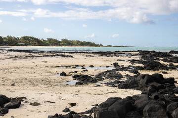 Fantastic sandy beach in the morning. An island in the Indian Ocean, landscape photo or seascape with the sun rising over the sea. There are small lava rocks on the beach 
Trou d'Eau Douce, Mauritius