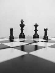 chess king, queen, rook pieces isolated on a chess board. © Saatvik