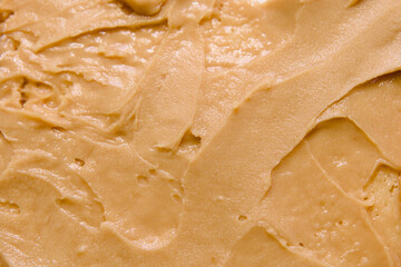 close up of peanut butter texture use as background or wallpaper