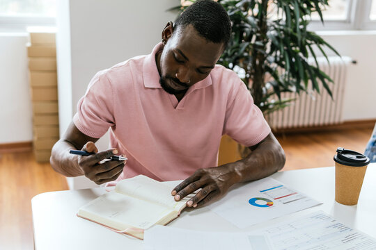 African American man working in a bright coworking space - Powered by Adobe