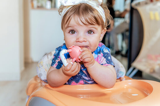 Baby girl enjoying her toy at home