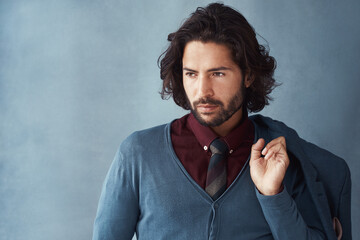 Thinking, male model and fashion in studio for business, trendy and smart casual by mock up space. Man, jacket and idea for outfit and elegance or confidence for luxury apparel by gray background