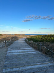 Fototapeta premium road made of wooden planks leading to the sea on a sunny day in Spain, path to the sea