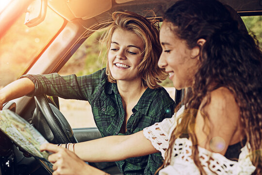 Car, reading map and friends travel on road trip, vacation and navigation for planning holiday. Happy women, girls and guide for direction in transport on journey, adventure and driving to location