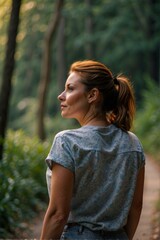 A woman standing in a lush green forest, wearing a blue shirt and jeans, looking at the view. AI.