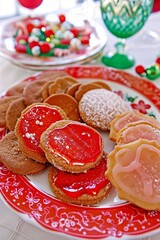 Festive Plate Of Christmas Cookies Featuring Red, Pink, White Icing, Some Sprinkled With Powdered Sugar
