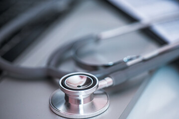 Close-up of a stethoscope on a computer keyboard, illustrating the integration of IT into medical practices.