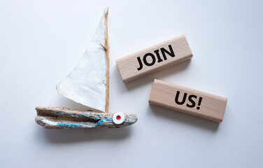 Join us symbol. Concept word Join us on wooden blocks. Beautiful white background with boat....