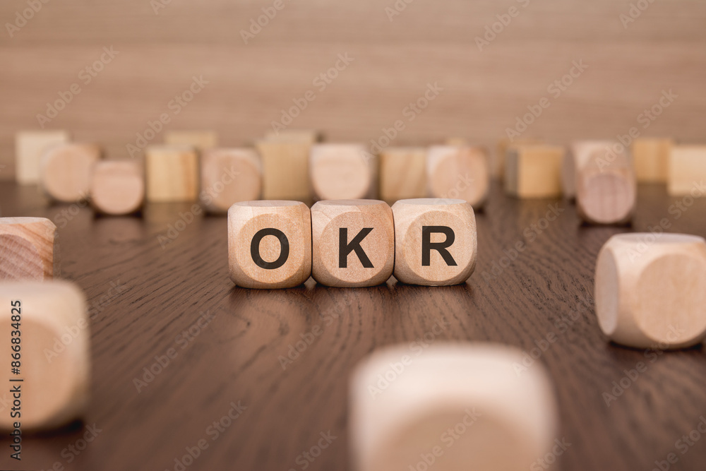 Aufkleber okr text 'objectives, key and results' wooden cube blocks on table background. business target and f