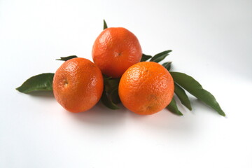 Mandarin fruit with leaves, on light background, the mandarin orange, Citrus reticulata