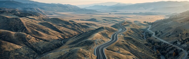 Aerial View of Highway Curving Through Autumn Hills