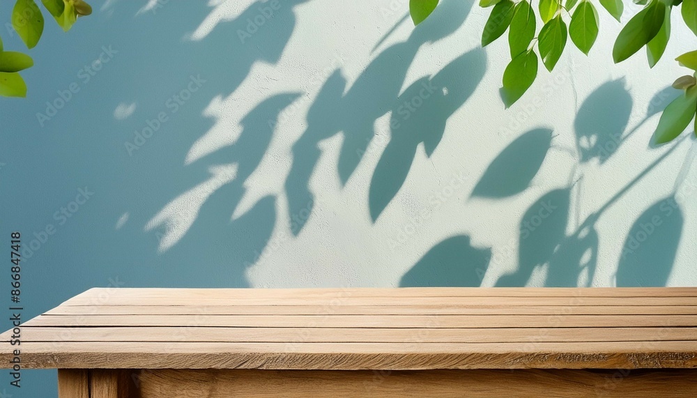 Poster empty wooden table on stucco background with natural shadow on the wall mock up for branding product