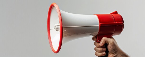 Naklejka premium Hand holding red and white megaphone, announcing concept
