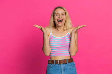 Happy joyful Caucasian woman celebrating success victory, winning birthday casino lottery jackpot achievement play game good positive news triumph. Young pretty girl isolated on pink studio background