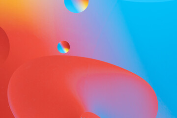 Colorful abstract background with dynamic bubble shapes. Red and blue gradient.
