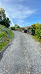 Paved road that goes up a mountain in a Galician town, As Eiras, O Rosal, Galicia